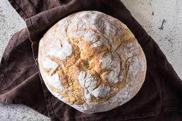 Freshly baked traditional bread on white rustic background
