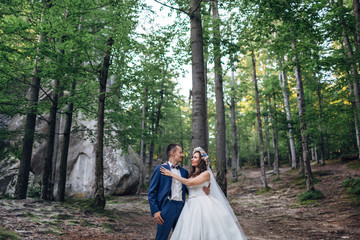 The brides embracing in the  forest