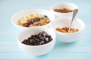 Healthy breakfast. Oatmeal with banana, almond nuts, blueberries and raisins.