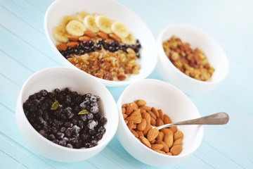 Healthy breakfast. Oatmeal with banana, almond nuts, blueberries and raisins.