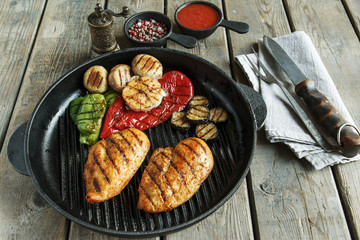 grilled chicken fillet breast  with vegetables on the grill pan