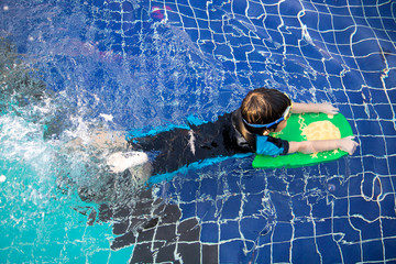 boy learn to swim in the swimming pool © sir.chitvises