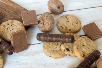 Cookies, walnut and chocolate on the white wooden background
