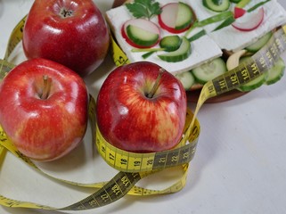 Diet - slimming .Weight loss concept with red apple, vegetables and dairy products
