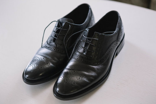 beautiful black leather and lacquered shoes for the groom