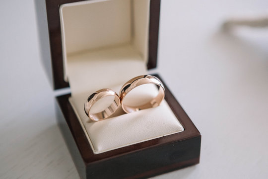 beautiful gold wedding rings lying in small gift box