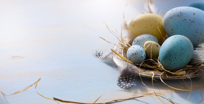 Happy Easter; Easter eggs on blue table background. Holidays view with copy space