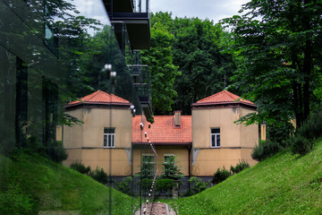 Reflection of a part of living building with red roof making it look like a castle. Fusion of epochs.