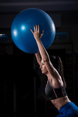 Beautiful Fitness Girl Holding Gym Ball Over Her Head