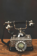 Vintage telephone on wooden table.