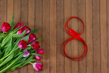 Fresh spring tulips, red tape on March 8