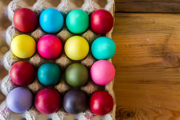 Fototapeta na wymiar Colorful Easter eggs on wood