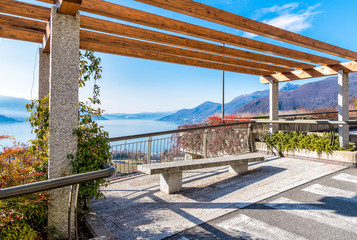 View of Lake Maggiore from the terrace with bench, Luino, province of Varese, Italy