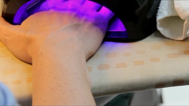 Drying Nails in the uv Lamp Nail Dryer Machine.