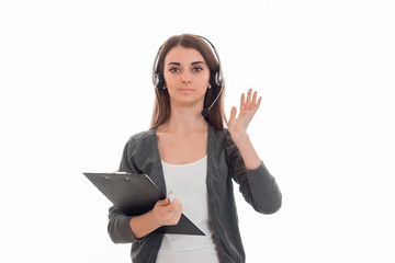 beautiful brunette woman working in call center with headphones and microphone posing on camera isolated on white background