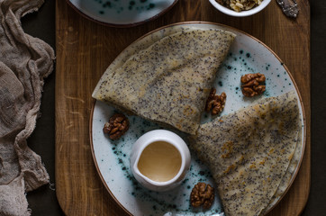 Pancakes on the apple juice with poppy seeds nuts and honey