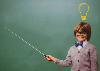 kid and blackboard with lightbulb against a black background