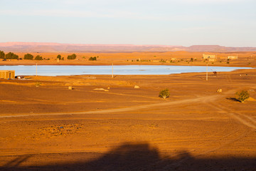 Fototapeta na wymiar sunshine in the lake yellow desert of morocco sand and dune