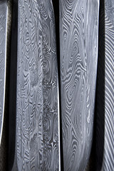 Damascus steel blade of knife. closeup of wootz, blacksmith forging process © annavolotkovska
