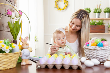 Fototapeta na wymiar Easter concept. Happy mother and her cute child getting ready for Easter