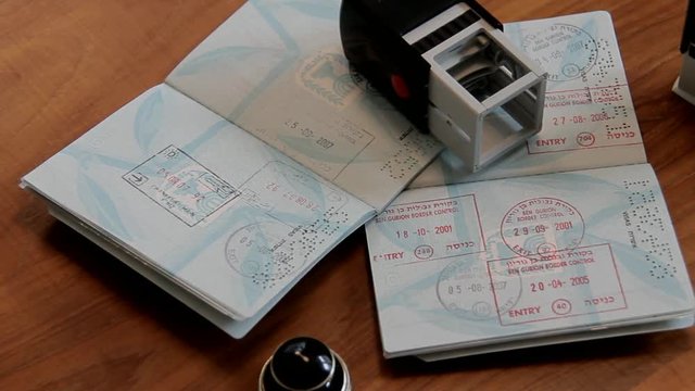 Passports and Stamps on Brown Wooden Desk