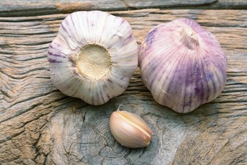 Garlic cloves on wooden vintage background.