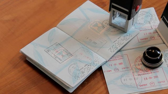 Passports and Stamps on Brown Wooden Desk