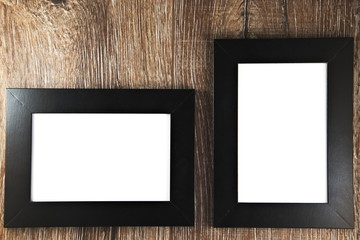 Blank photo frames on wooden background