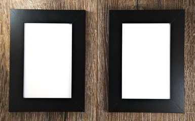 Blank photo frames on wooden background