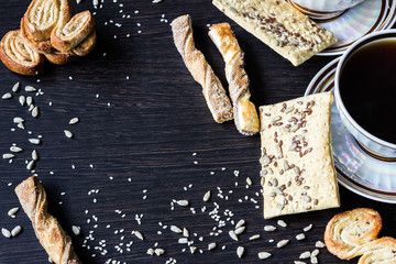 cup of coffee with puff pastries with sunflower seeds, sesame seeds and flax