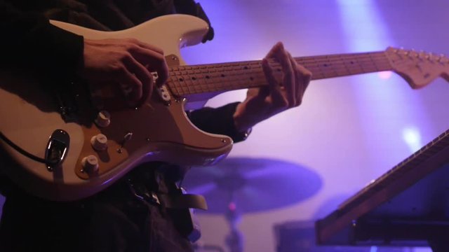 Electric guitar player on stage - finger picking chords