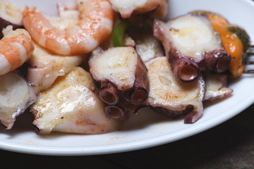 Tasty seafood salad with white plate. Horizontal shoot.