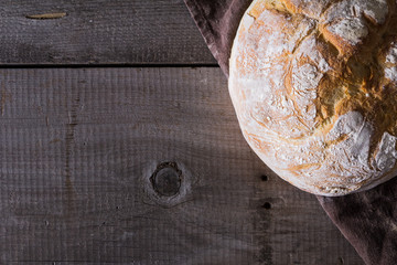 Freshly baked traditional bread on wooden table