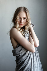 Fototapeta premium portrait of young sexy woman posing near the gray wall