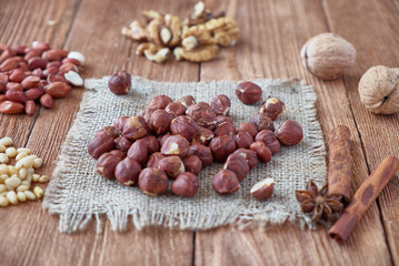 Cinnamon sticks, anise, coffee beans and nuts on a wooden background
