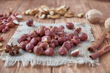 Cinnamon sticks, anise, coffee beans and nuts on a wooden background
