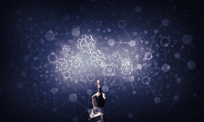 Glowing cogwheel mechanism icon on dark background as symbol of 