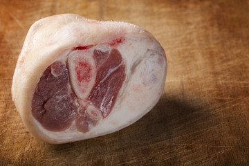 Close up of one piece of raw pork on wood