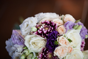 Wedding rings on the bride's bouquet