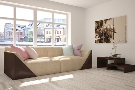 White room with sofa and winter landscape in window. Scandinavian interior design