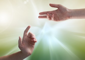Composite image of Hands against illuminated green background
