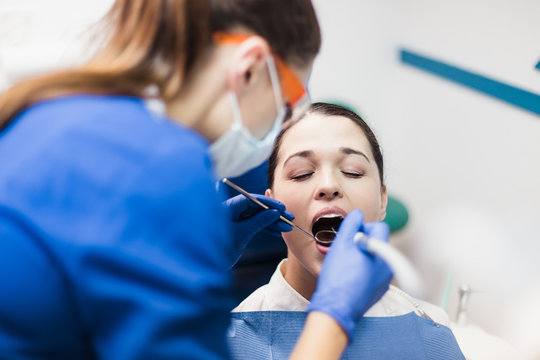 The patient in the dental office make painful procedure