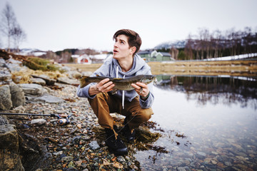 Boy shows his caught fish
