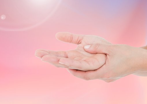 Composite image of Hands against pink background