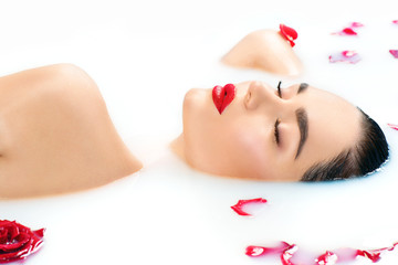 Plakat Beautiful fashion model girl taking milk bath, spa and skincare concept