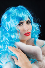 a girl is in a blue wig