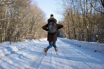 Walking girl in winter forest