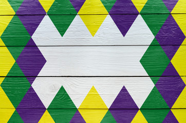 Diamond green, purple, yellow pattern painted Mardi Gras holiday background. Empty space for copy,...