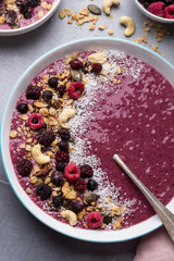 Healthy breakfast smoothie bowl with fresh berries and home made granola; Overhead view