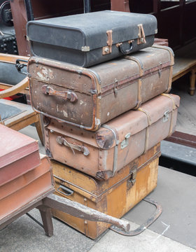 Stack of old luggage cases at a train station